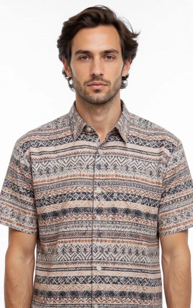 A French model wearing a Tribal pattern   printed shirt, against a white background, in a front   facing bust portrait